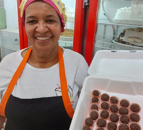 Dona Maria com uma caixa de brigadeiros